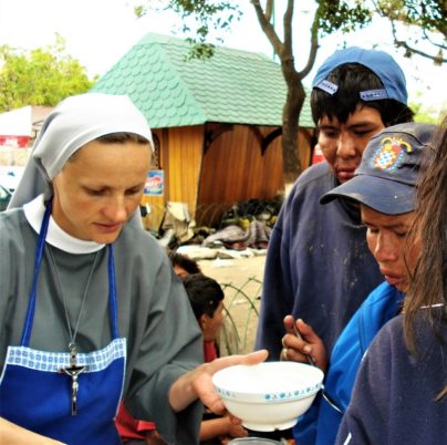 An Albertine Sister serving food the the missions
